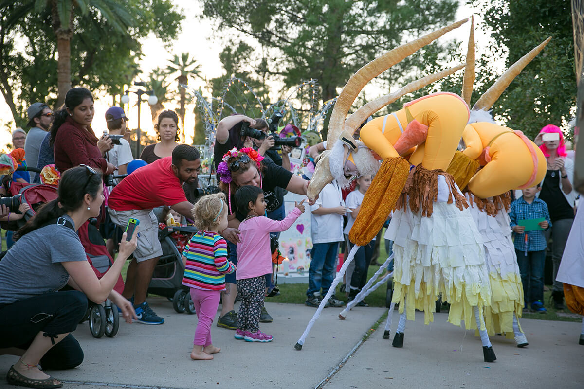 Children delight in the mythical creatures visiting them during the Procession of Little Angels.