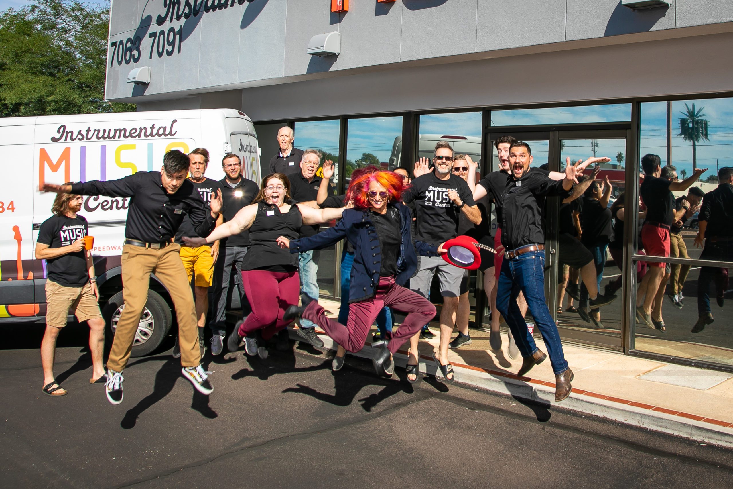 Leslie Stirm, owner of Instrumental Music Inc in Tucson AZ and her staff jump in the air to illustrate that they are a fun group and business. Kathleen's images from their session were featured in the national magazine, Music Inc., December 2021 edition.