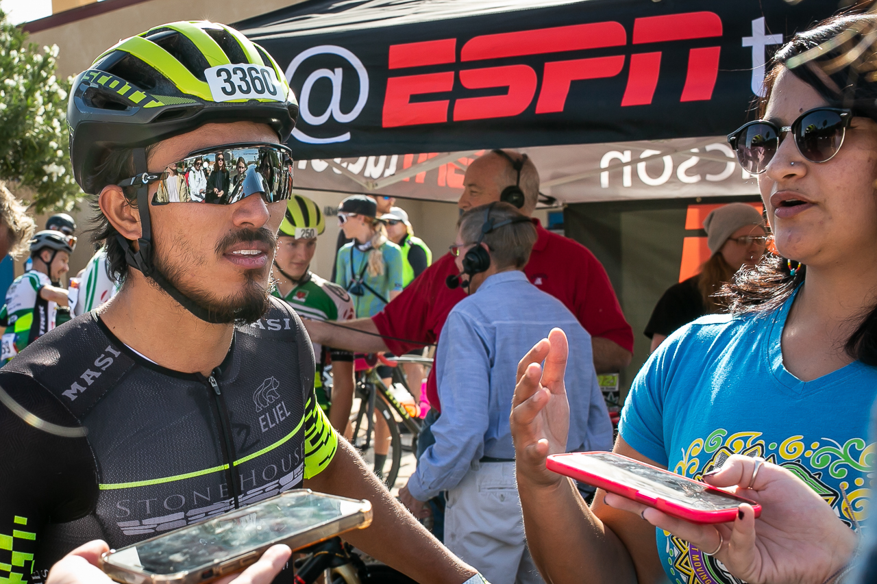 Gerardo Ulloa from Mexico, the 2021 El Tour De Tucson winner is interviewed by ESPN and other media outlets immediate upon completing his race. El Tour organizers hired Kathleen to document the authentic community nature of their annual event.