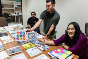 Dr. Krystal Tsosie and her graduate student review art created in the Biology and Society course at Arizona State University. The art will be used to create a paper quilt for the Life Sciences building -Kathleen Dreier Photography