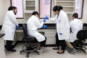 Dr. Krystal Tsosie and her Arizona State University graduate students give a demonstration of work that will be completed in their rennovated laboratory-Kathleen Dreier Photography