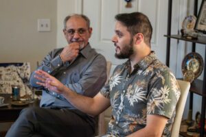 Mr. Kashmoola looks at his son Bahjat during an engaging conversation in their home. With the support of non-profits Welcome Corp and Community Sponsorship Hub, Mr. Mazen Kashmoola and his son Mustafa were reunited with Bahjat, their son and brother in Phoenix, Arizona. The joyous occasion was documented by Kathleen Dreier Photography.