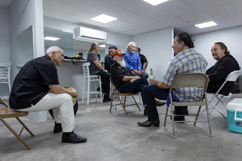 RJ Mischo, members of the Red Hot Band, and the Arizona Blues Hall of Fame relax in the "green" room at El Casino Ballroom before their performance. Image by Kathleen Dreier Photography.