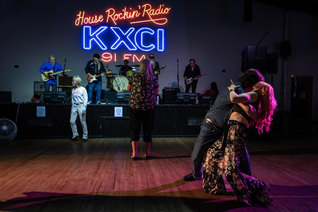 A couple are among the first on the dance floor at the start of the KXCI House Rockin Blues concert at the El Casino Ballroom. Image by Kathleen Dreier Photography.