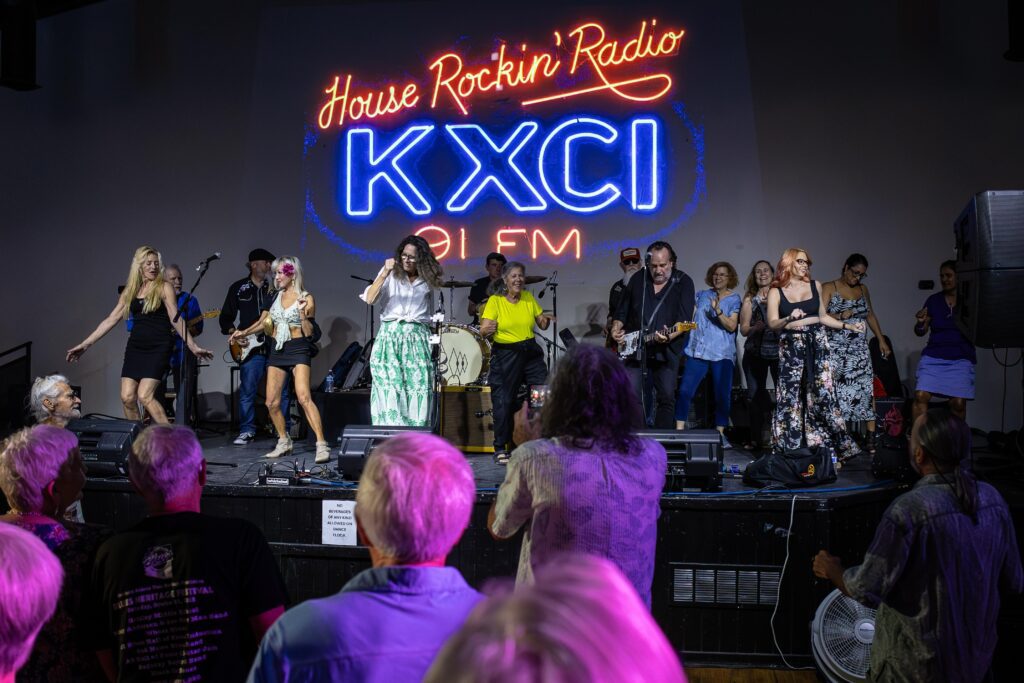 Audience members dance on the stage with the Arizona Blues Hall of Fame musicians during KXCI's House Rockin Blues concert at El Casino Ballroom. Image by Kathleen Dreier Photography.