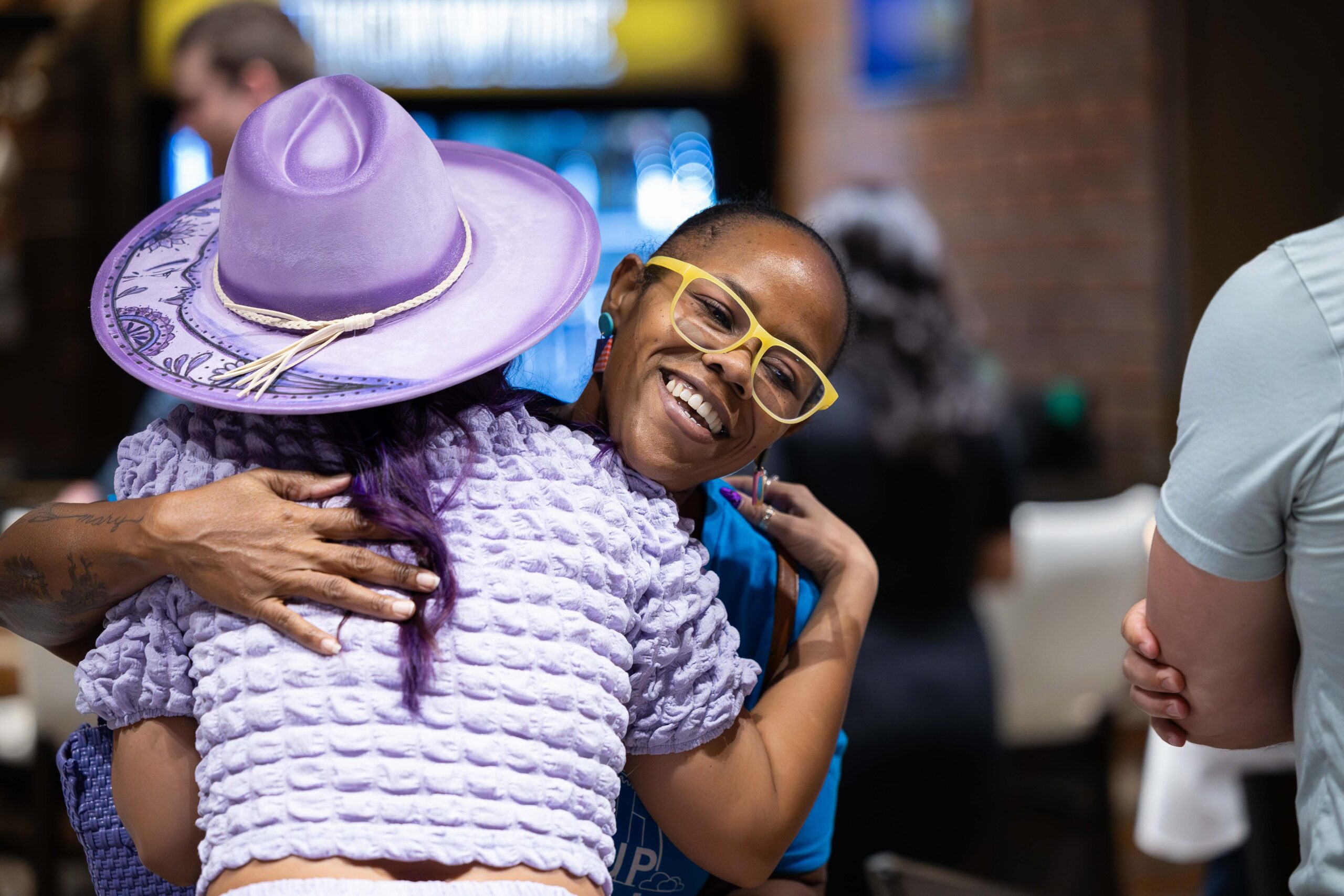 Keneshia Raymond, Startup Tucson greets Celena Santa Cruz of LUNA ZEN during the "Monsoon Mixer", a collaboration networking event between Local First Arizona, StartUp Tucson, and the LGBT Chamber of Commerce. Image by Kathleen Dreier Photography.